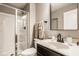 Clean bathroom featuring a glass-enclosed shower, white vanity, dark hardware, and a stylish mirror at 14910 Briarpatch Cir, Carmel, IN 46033