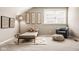 This attic bedroom has neutral-toned walls, carpet, decor, and natural lighting at 14910 Briarpatch Cir, Carmel, IN 46033