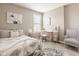 Bright bedroom featuring a bed, window, desk, and chair, creating a comfortable and functional space at 14910 Briarpatch Cir, Carmel, IN 46033