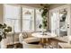 Bright breakfast nook with a marble table, modern seating, and oversized windows at 14910 Briarpatch Cir, Carmel, IN 46033