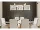 Chic dining room with neutral tones, textured wallpaper, and eye-catching light fixture at 14910 Briarpatch Cir, Carmel, IN 46033