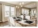 Spacious dining room with ample natural light, stylish furnishings, and modern lighting at 14910 Briarpatch Cir, Carmel, IN 46033