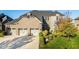 Stunning two-story home with a three-car garage and lush landscaping creates appealing curb appeal at 14910 Briarpatch Cir, Carmel, IN 46033