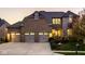 Stately brick and stone home with a three-car garage and manicured landscaping at 14910 Briarpatch Cir, Carmel, IN 46033