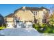 Charming two-story home boasts a three-car garage and a well-manicured lawn with landscaping at 14910 Briarpatch Cir, Carmel, IN 46033