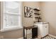 Light-filled laundry room with shelves, sink, and hamper at 14910 Briarpatch Cir, Carmel, IN 46033
