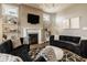Bright living room with a fireplace, a modern geometric rug, and stylish couches at 14910 Briarpatch Cir, Carmel, IN 46033
