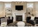 Comfortable living room featuring a fireplace, large television, modern lighting, and stylish decor at 14910 Briarpatch Cir, Carmel, IN 46033