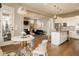 Open-concept living space featuring hardwood floors, a modern kitchen, and a cozy living room at 14910 Briarpatch Cir, Carmel, IN 46033