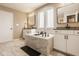 This primary bathroom features dual vanities, soaking tub and many windows at 14910 Briarpatch Cir, Carmel, IN 46033
