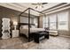 Stylish bedroom featuring a four-poster bed and patterned accent wall at 14910 Briarpatch Cir, Carmel, IN 46033