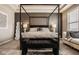 Luxurious bedroom with a four-poster bed, patterned wallpaper, and a cozy bench at 14910 Briarpatch Cir, Carmel, IN 46033