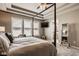 This primary bedroom features a four-poster bed, wall-mounted television, and bedside table at 14910 Briarpatch Cir, Carmel, IN 46033