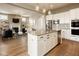 Open concept kitchen and living room, featuring stainless steel appliances and a fireplace at 14910 Briarpatch Cir, Carmel, IN 46033