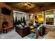 Cozy covered patio with brickwork, comfortable wicker seating, and tranquil green backyard views at 14910 Briarpatch Cir, Carmel, IN 46033