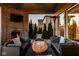 Relaxing covered patio featuring brick accents, cozy seating, and views of the green yard at 14910 Briarpatch Cir, Carmel, IN 46033