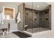 This gorgeous glass shower has dark brown brick-like tile and pebble flooring at 14910 Briarpatch Cir, Carmel, IN 46033