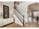 Elegant staircase with wooden floors and a stylish console table creating a welcoming ambiance at 14910 Briarpatch Cir, Carmel, IN 46033