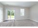 Sunlit bedroom features a sliding glass door to the backyard at 15391 Mystic Rock Dr, Carmel, IN 46033