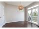 Bright dining area features a modern light fixture and sliding glass door to an exterior balcony at 15391 Mystic Rock Dr, Carmel, IN 46033