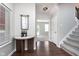 Welcoming foyer with hardwood floors and a stylish console table with decorative items at 15391 Mystic Rock Dr, Carmel, IN 46033
