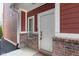 Inviting front entrance with red brick and white trim, exuding classic charm at 15391 Mystic Rock Dr, Carmel, IN 46033