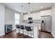 Bright eat-in kitchen boasts granite counters, stainless appliances, an island with barstool seating, and a wine cooler at 15391 Mystic Rock Dr, Carmel, IN 46033