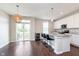 Eat-in kitchen features granite counters, stainless appliances, wine cooler, island and sliding glass door at 15391 Mystic Rock Dr, Carmel, IN 46033