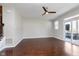 Spacious living room featuring hardwood floors, a ceiling fan, and access to an outdoor balcony at 15391 Mystic Rock Dr, Carmel, IN 46033