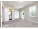 Spacious main bedroom with ensuite bathroom, sliding glass doors to a small patio, neutral paint and new carpet at 15391 Mystic Rock Dr, Carmel, IN 46033
