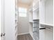 Walk-in closet with custom shelving, drawers, and natural light at 15391 Mystic Rock Dr, Carmel, IN 46033