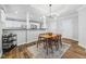 Bright dining area showcasing modern lighting, hardwood floors, and an open layout at 1557 N College Ave # 3, Indianapolis, IN 46202