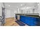 Modern kitchen with granite countertops, stainless steel appliances, and white and blue cabinets at 1557 N College Ave # 3, Indianapolis, IN 46202