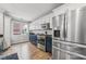 Modern kitchen with stainless steel appliances, white and navy cabinets, and lots of light at 1557 N College Ave # 3, Indianapolis, IN 46202