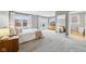 Bright main bedroom boasts lots of natural light, neutral paint, and access to an ensuite bathroom at 1557 N College Ave # 3, Indianapolis, IN 46202