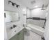 Renovated bathroom featuring new tiling, shower, lighting, tub and a green vanity with a light countertop at 1711 Ringgold Ave, Indianapolis, IN 46203