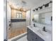 Modern bathroom with double sinks and a large shower featuring cedar elements, multiple shower heads and tiled walls at 1711 Ringgold Ave, Indianapolis, IN 46203