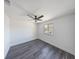 A well lit bedroom features modern ceiling fan, grey floors, and white walls with a street view at 1711 Ringgold Ave, Indianapolis, IN 46203