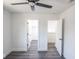 A well lit bedroom features modern ceiling fan, grey floors, and white walls with access to other rooms at 1711 Ringgold Ave, Indianapolis, IN 46203