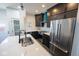 Well-lit kitchen features stainless steel appliances, dark cabinets, and a white countertop island at 1711 Ringgold Ave, Indianapolis, IN 46203