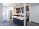 Kitchen with white countertops, stainless steel appliances, dark cabinets, and wood floors at 1711 Ringgold Ave, Indianapolis, IN 46203