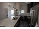 Modern kitchen with stainless steel appliances, dark cabinetry, and a large island with pendant lighting at 1711 Ringgold Ave, Indianapolis, IN 46203