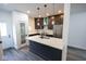 Modern kitchen with a large island, marble countertops, stainless steel appliances, and dark cabinets at 1711 Ringgold Ave, Indianapolis, IN 46203