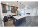 Spacious kitchen with stainless steel appliances, dark cabinets, and island with sink and faucet at 1711 Ringgold Ave, Indianapolis, IN 46203