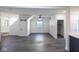 Spacious living area with wood floors, barn door, and ample room for customization at 1711 Ringgold Ave, Indianapolis, IN 46203