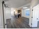 Bright open-concept living area with gray wood floors, white walls, and a modern kitchen at 1711 Ringgold Ave, Indianapolis, IN 46203
