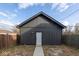 Backyard outbuilding with modern siding, a concrete path, and a white door at 1711 Ringgold Ave, Indianapolis, IN 46203