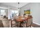 Sunlit dining room showcases a modern chandelier, elegant furniture, and sliding glass doors to the outdoor at 17346 Haxby Ln, Westfield, IN 46074