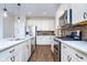 Well-appointed kitchen with stainless steel appliances, custom cabinets, and granite countertops offers style at 17346 Haxby Ln, Westfield, IN 46074
