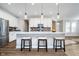 Modern kitchen boasts white cabinets, a stylish backsplash, pendant lighting, and stainless steel appliances at 17346 Haxby Ln, Westfield, IN 46074
